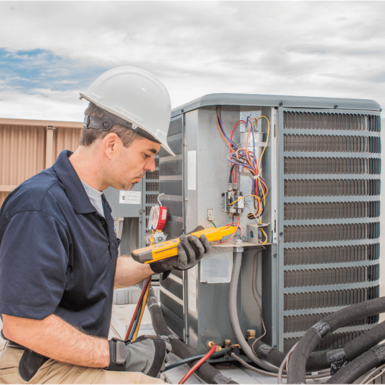 Sarnia Heating & Cooling HVAC technician servicing a system